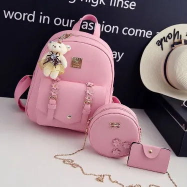 Women's three-piece PU leather bag set showing backpack, shoulder bag, and card holder in matching colour