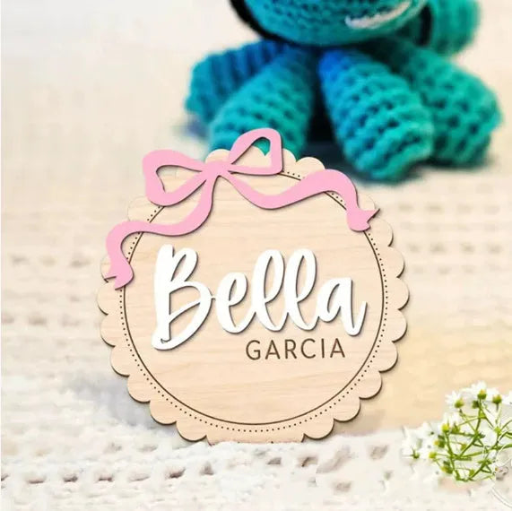 Square wooden ornament laser-engraved with a custom name for baby room decoration.