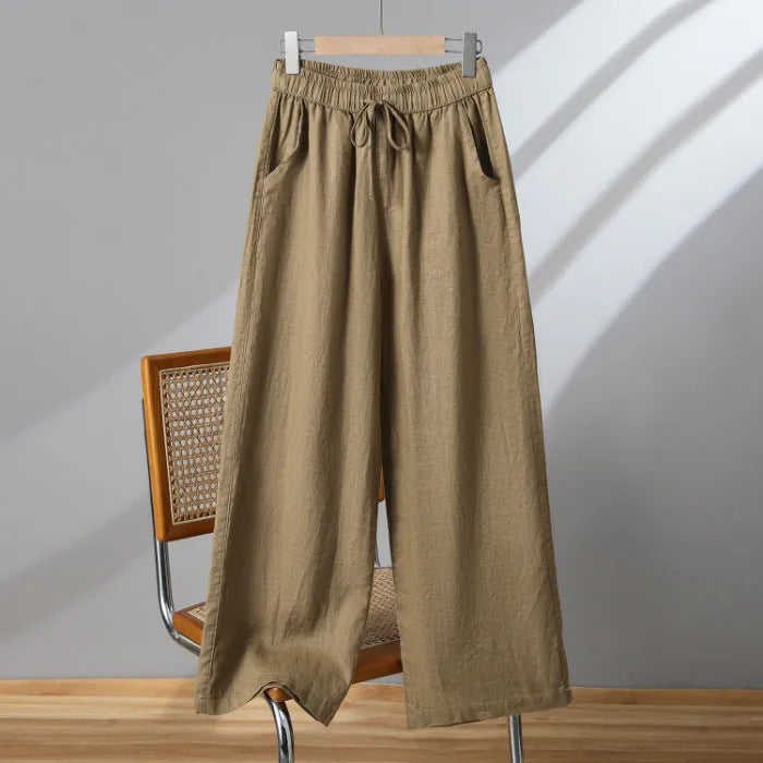 Women's apricot straight-leg casual trousers with an elastic lace-up waistband on a hanger.