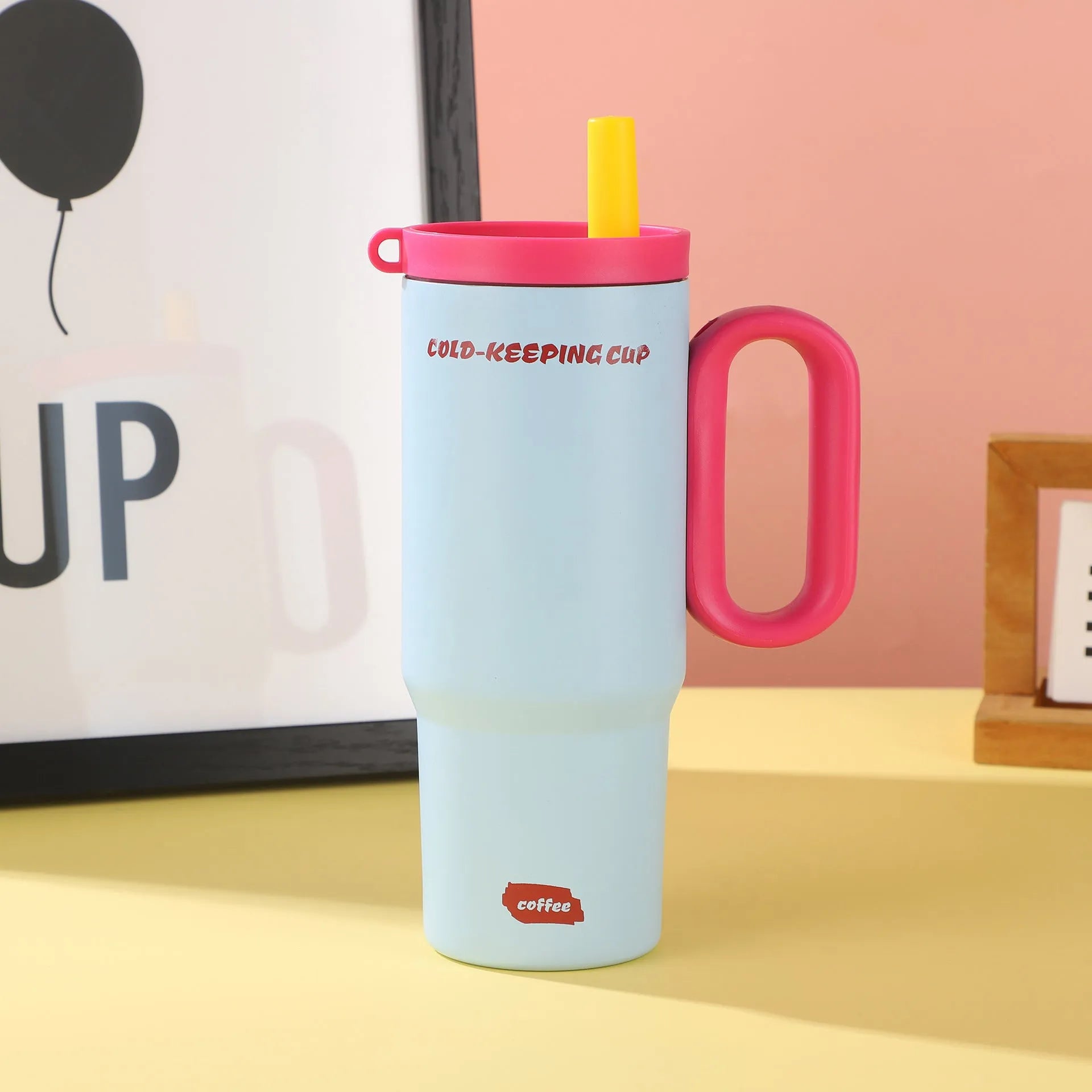 Large insulated straw drinking cup with a carrying handle in various colours.