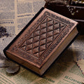 Embossed faux leather notebook in bronze colour, open to show thick white pages.