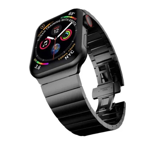 Silver metal Apple Watch strap with butterfly buckle on a wrist, showing the clasp closed.
