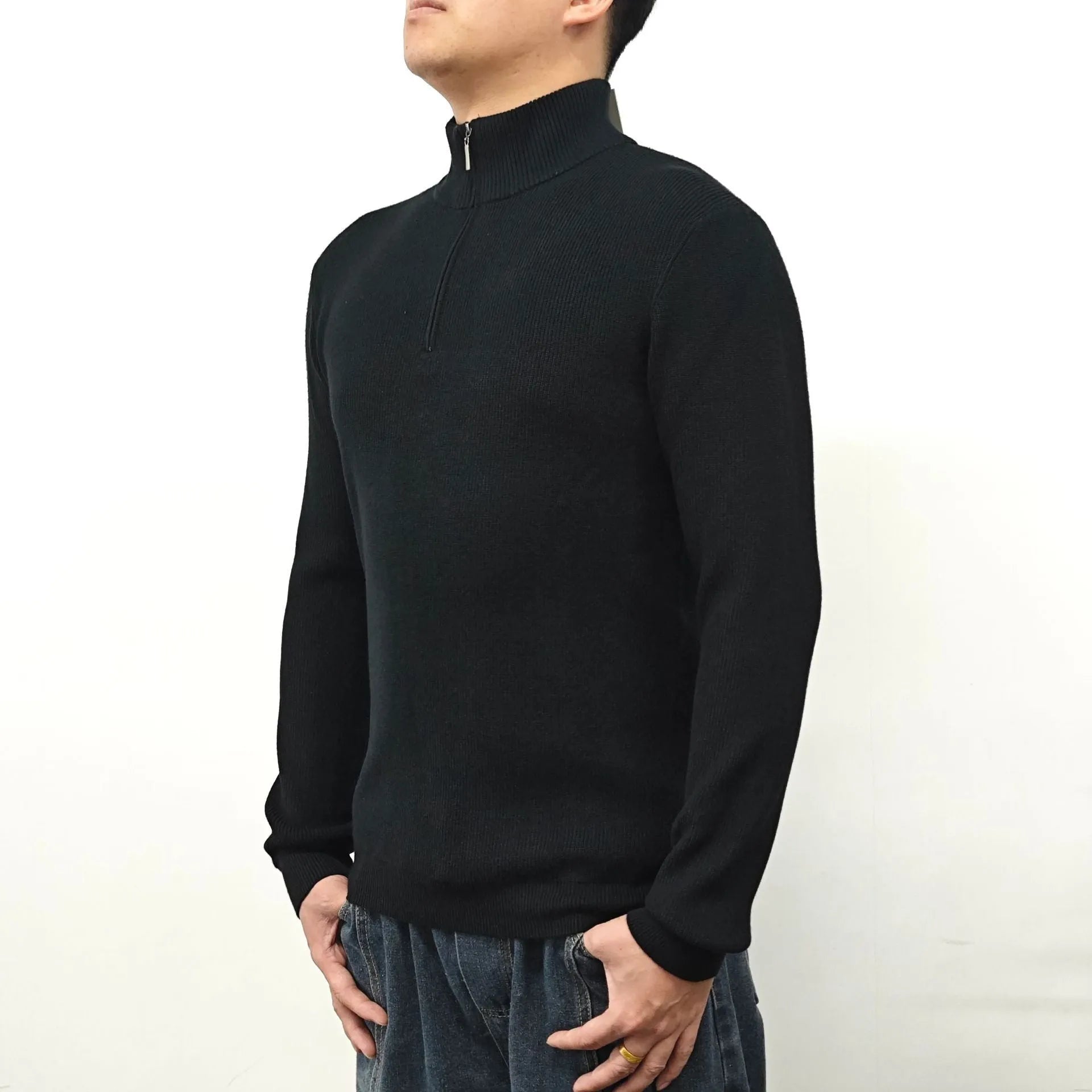 Man wearing a grey half-turtleneck zipper sweater, a cotton blend pullover for casual wear.