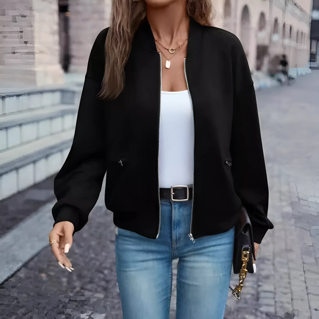 Women's solid black polyester zip jacket with long sleeves and faux pockets
