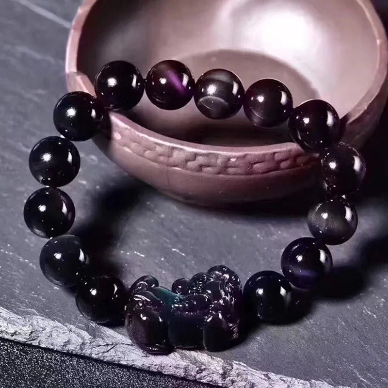 Natural ice colour obsidian crystal bracelet showing pale stone beads on wrist
