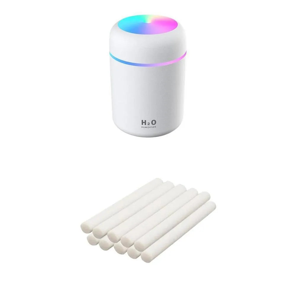 Pink USB portable humidifier with 300ml water tank on wooden desk surface