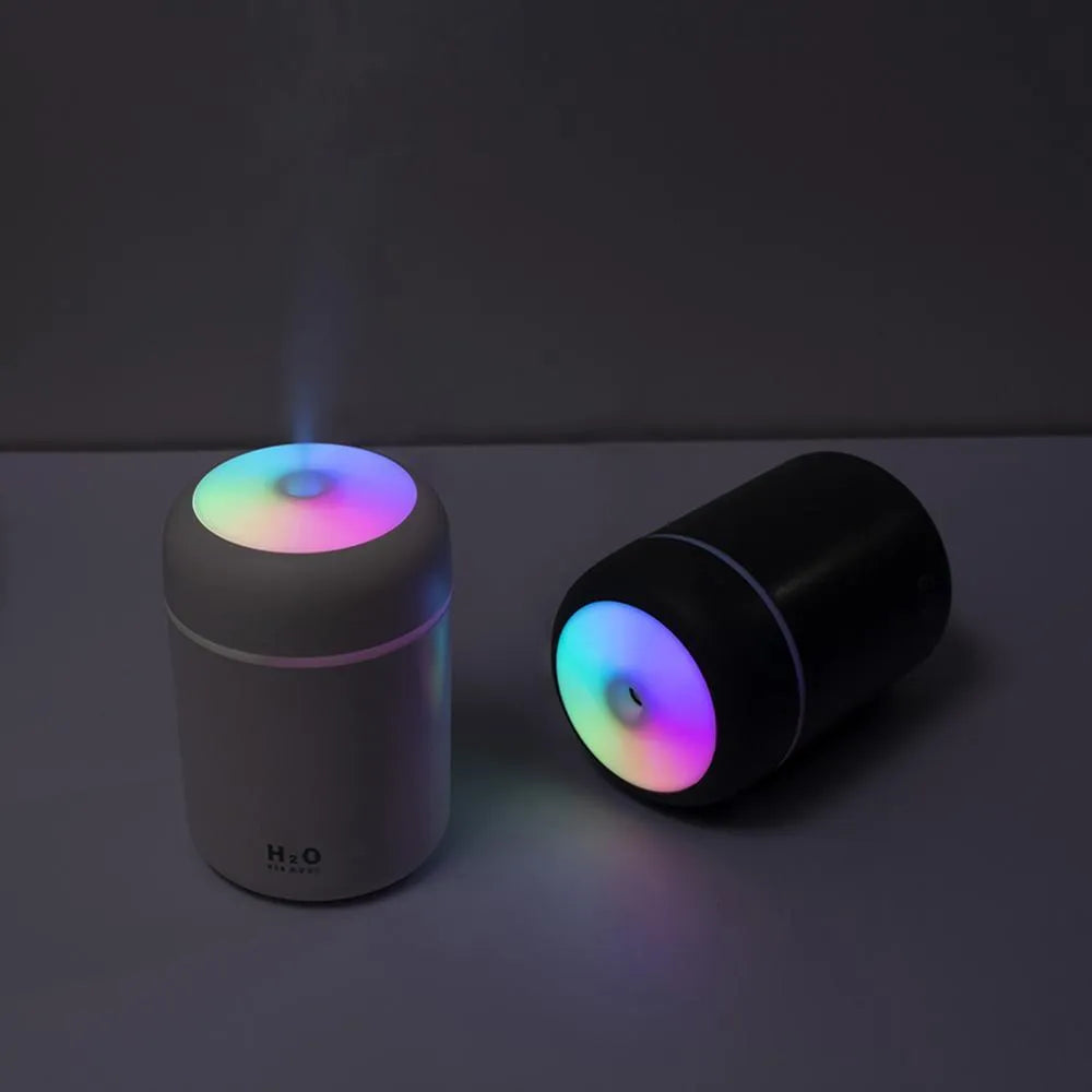 Pink USB portable humidifier with 300ml water tank on wooden desk surface