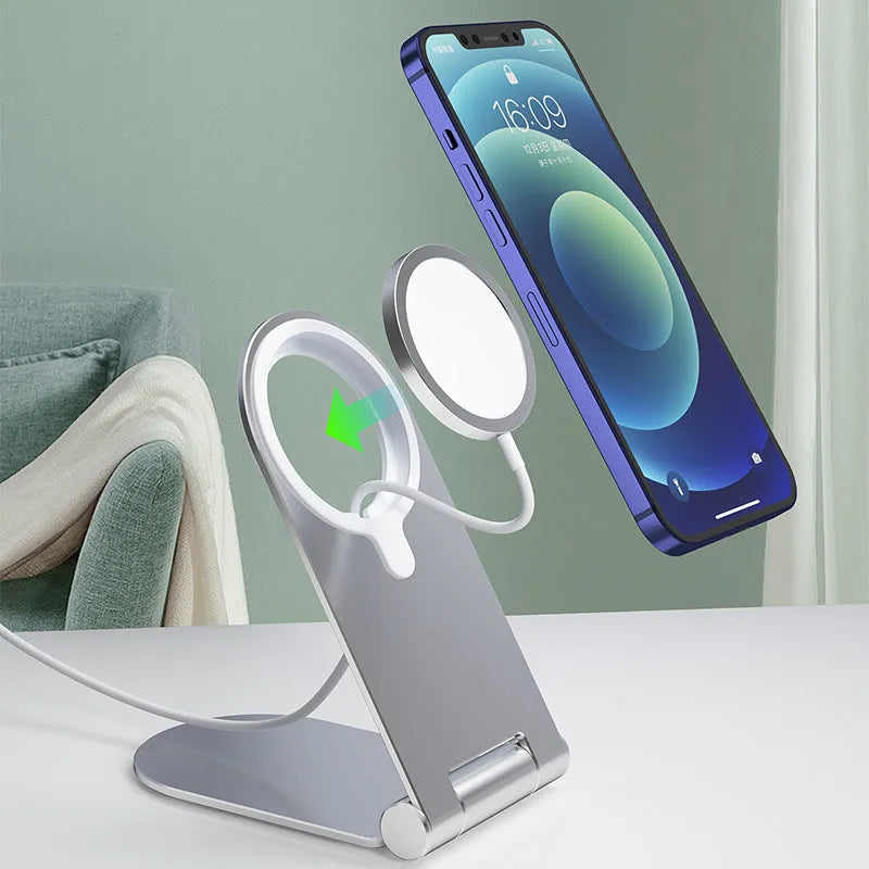 Silver vertical adjustable magnetic phone bracket for iPhone 12 on a flat surface.