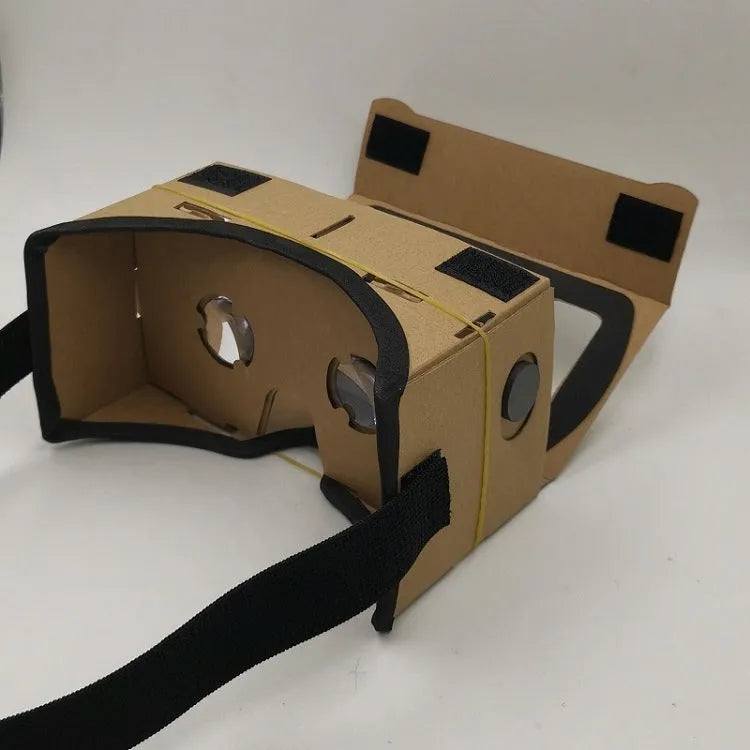 Foldable pink and white cardboard VR headset for smartphones with lenses and a head strap.