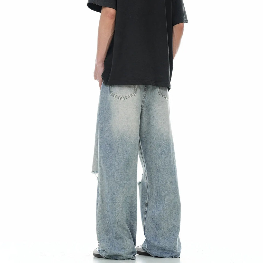 Men's blue straight-leg jeans with ripped details and zipper fly in retro style
