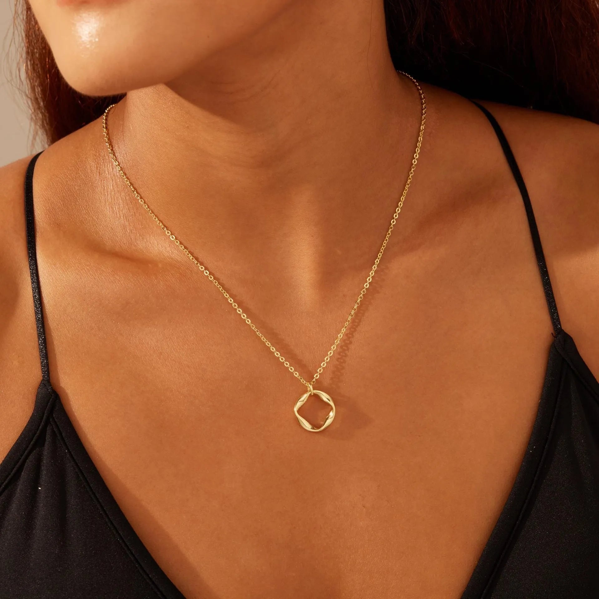 Copper electroplated layered clip necklace with circle pendant in gold finish