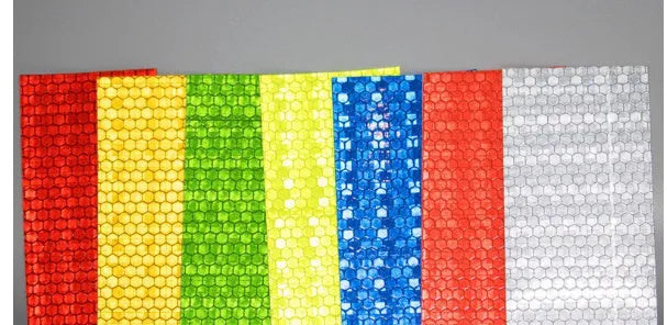 Close-up of solid colour reflective stripe roll with crystal lattice pattern, 10mm width, 8m length, in grass green colour.