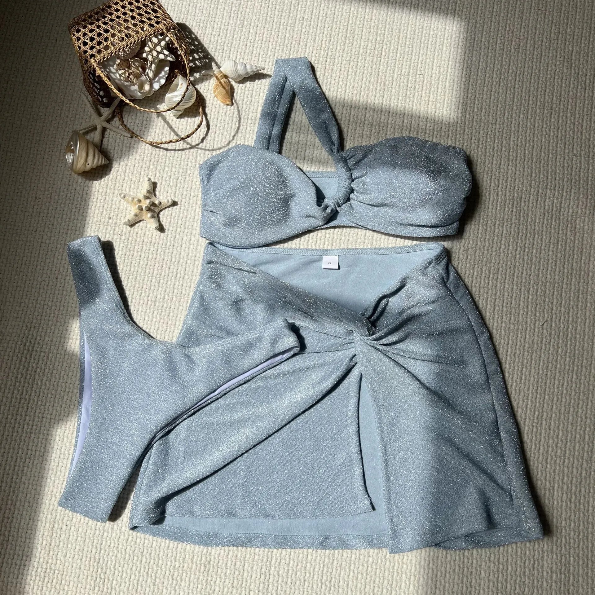 Light green one-shoulder tube top three-piece swimsuit set with matching skirt.
