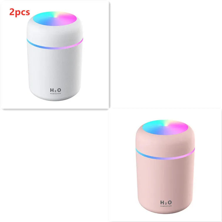 Pink USB portable humidifier with 300ml water tank on wooden desk surface