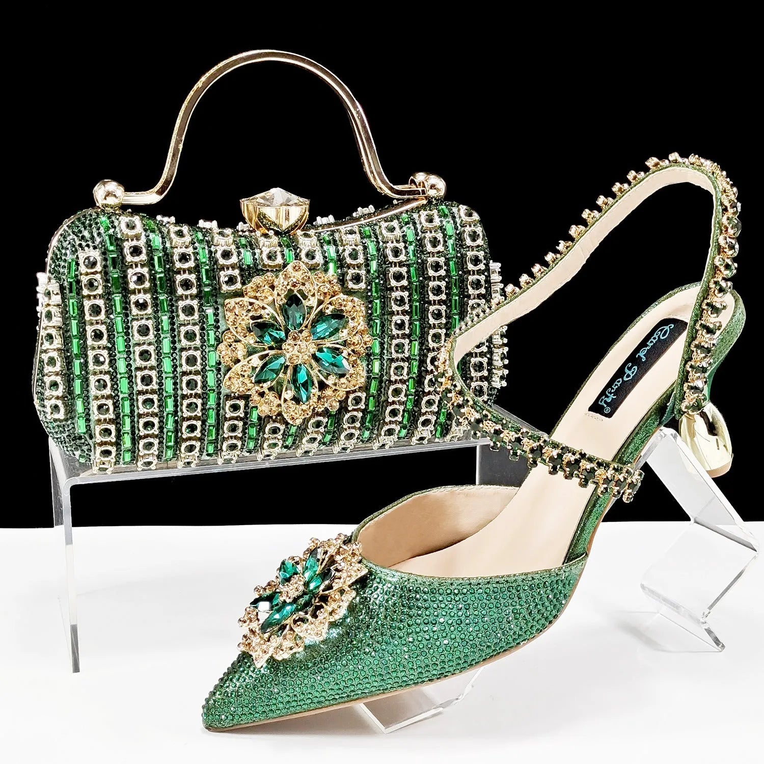 Women's black synthetic leather high-heel shoes with rhinestone ankle chain and matching hard clutch bag.