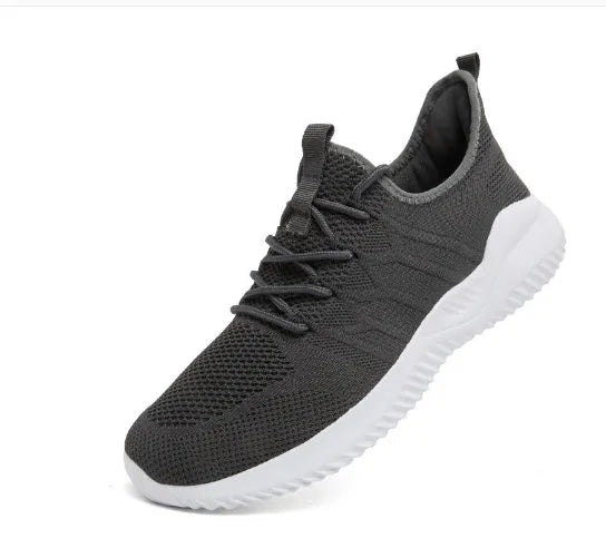 Men's black and white casual sneakers with breathable mesh upper and lace-up closure on a PVC sole.