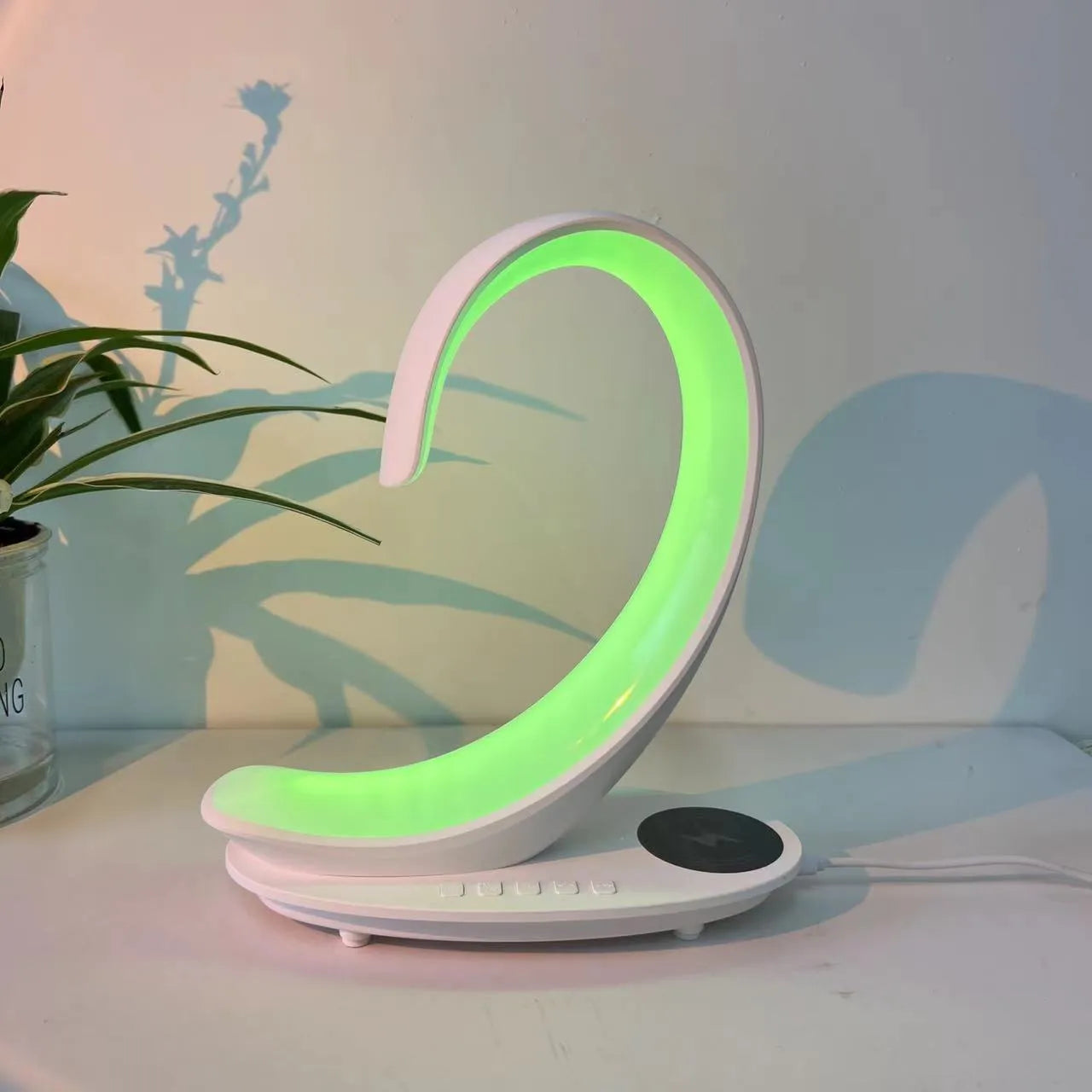 White swan shaped desktop lamp with wireless charging pad, Bluetooth speaker and colourful LED mood lighting