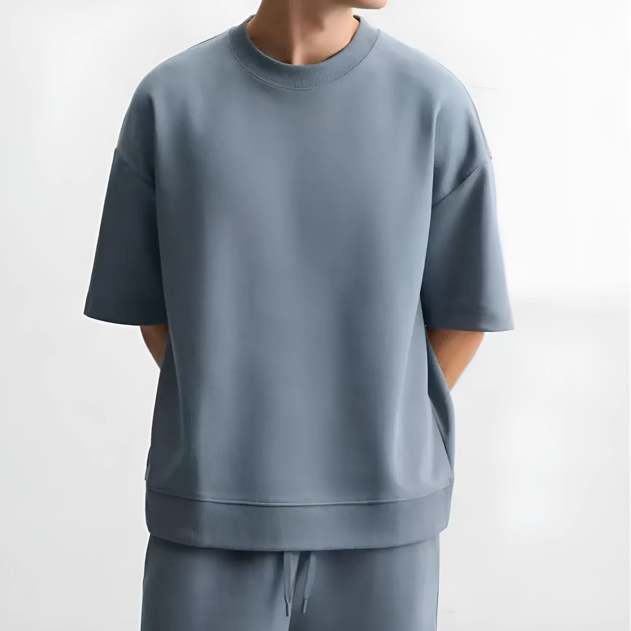 Loose-fitting short sleeve top and matching shorts set in blue, shown on a mannequin.
