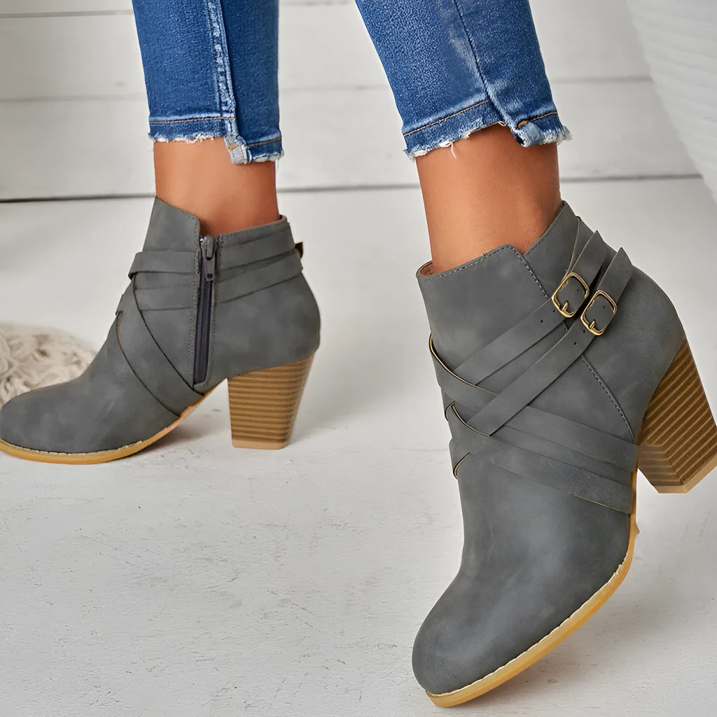 Women's black short boots with a 7cm stout heel and side zip fastener on a rubber sole.