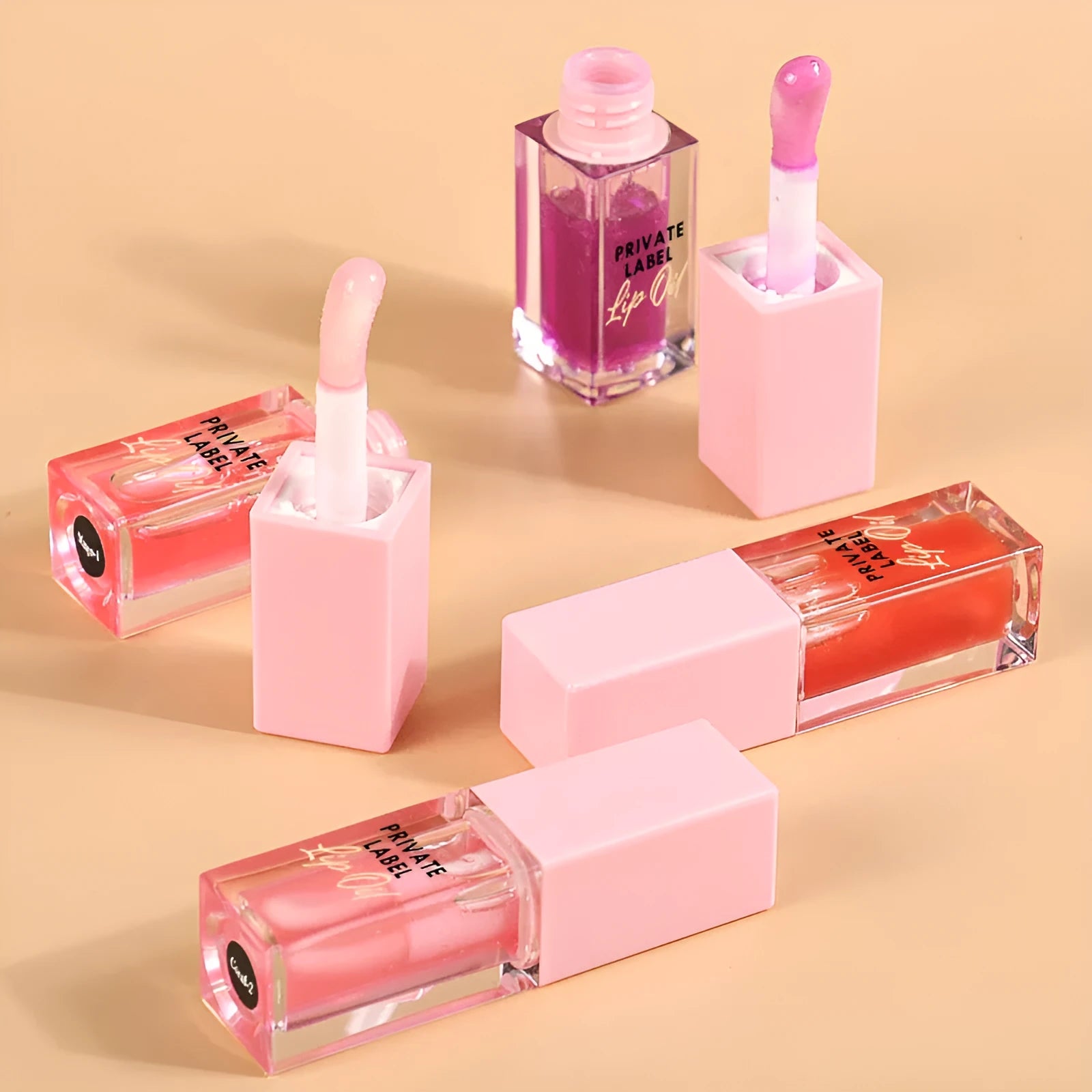 Transparent lip gloss tube showing six fruit shade options including cherry and watermelon