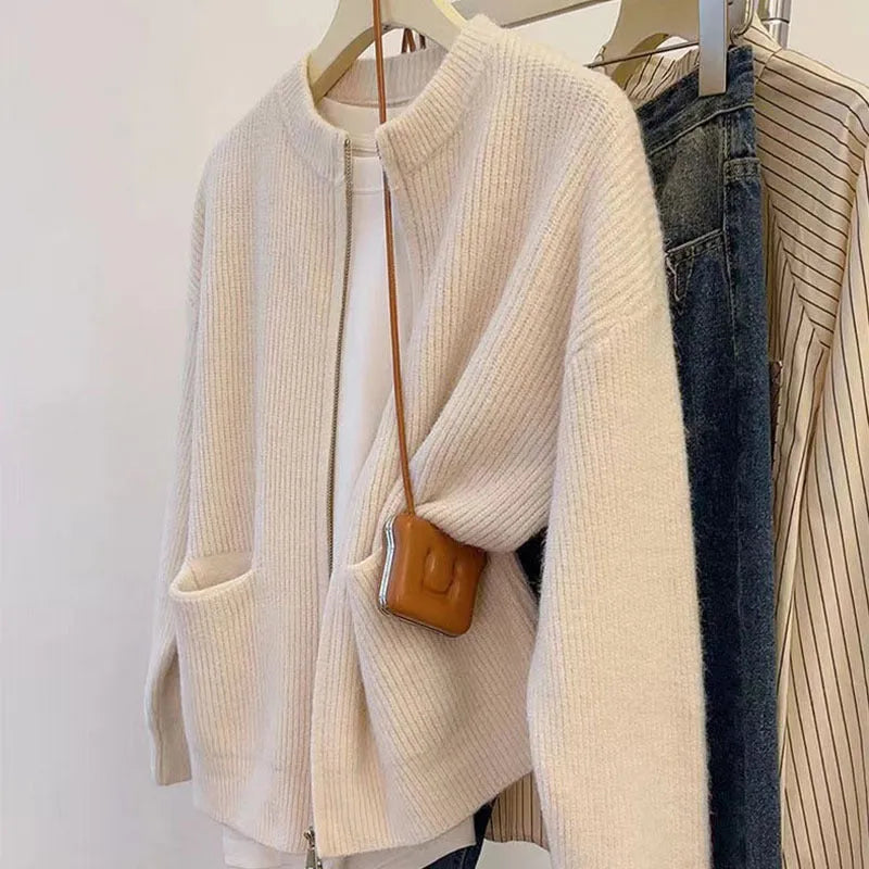 Beige viscose fibre soft wind cardigan coat with long sleeves on a hanger.
