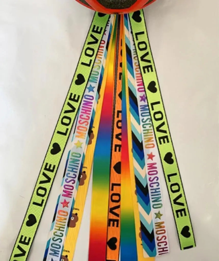 Close-up of a colourful decorative ribbon streamer attached to a child's helmet for roller skating or skiing.