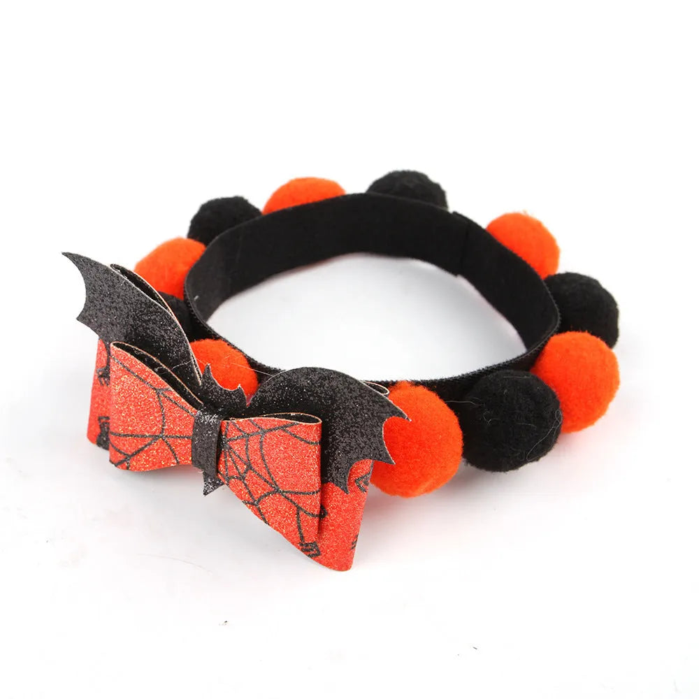 Halloween pet collar with a furry ball accessory in a pumpkin design on a dog's neck.