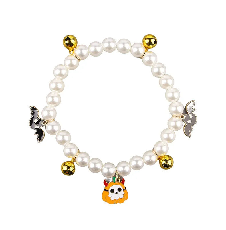 Halloween cat collar with simulated pearls and pumpkin charms in purple ghost, skull, and smiling designs