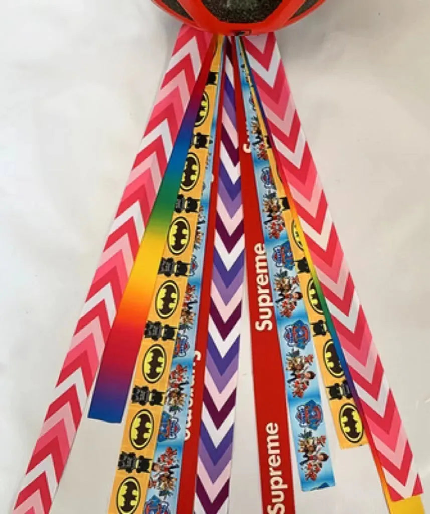 Close-up of a colourful decorative ribbon streamer attached to a child's helmet for roller skating or skiing.