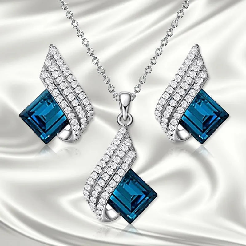Women's cross chain necklace and earrings set with glass pendant and electroplated finish.