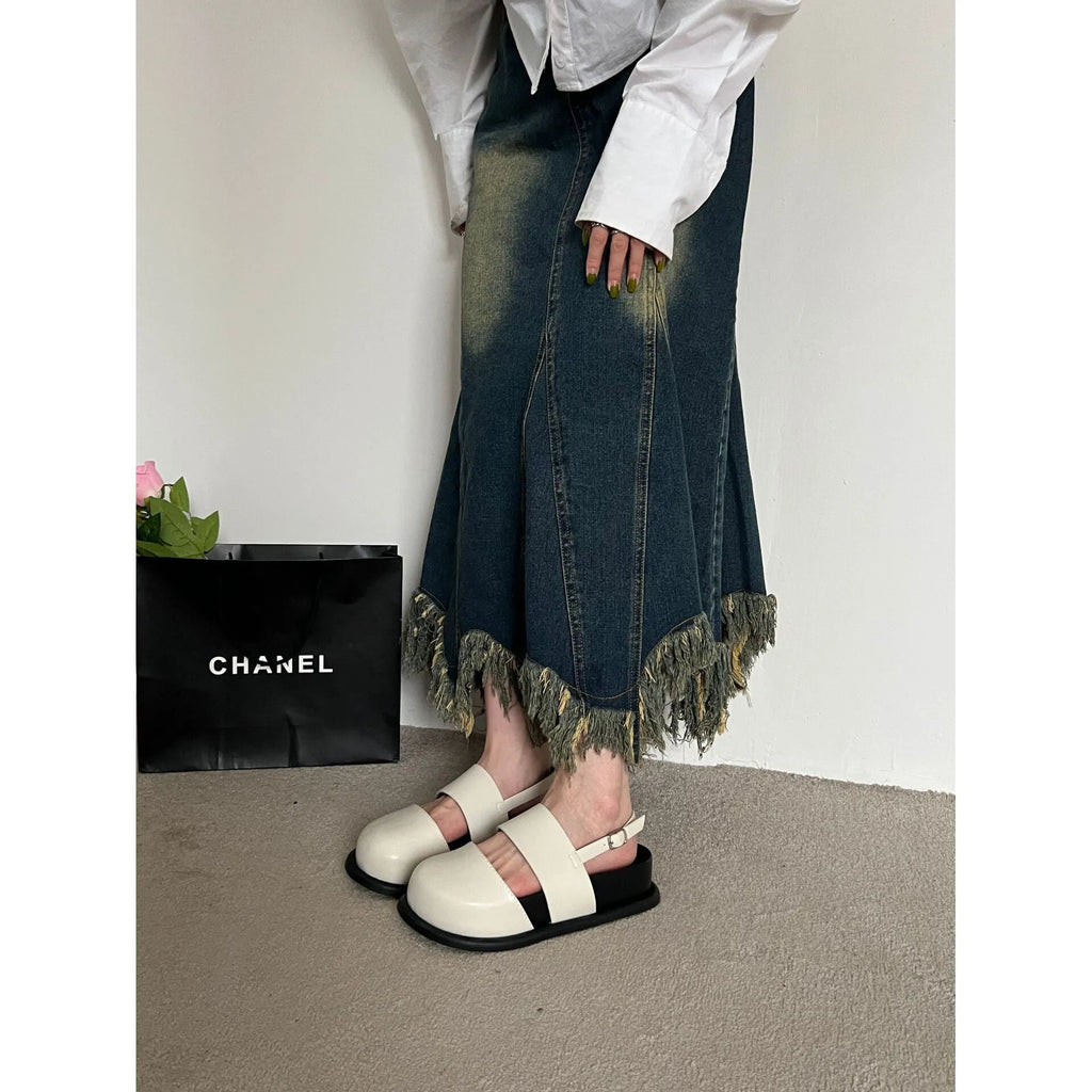 Retro closed toe sandals with raised bottom, ankle strap buckle, and round toe in apricot colour