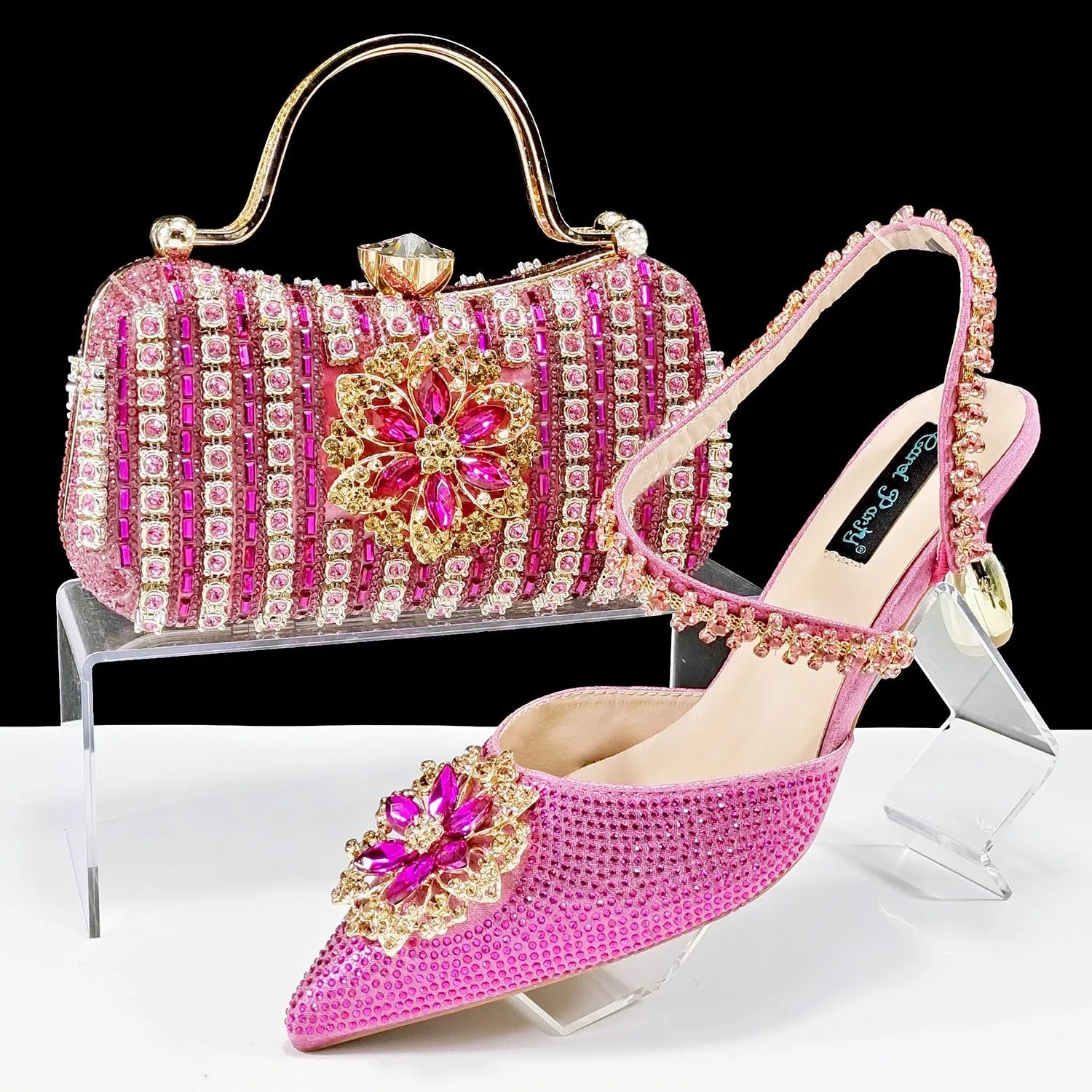 Women's black synthetic leather high-heel shoes with rhinestone ankle chain and matching hard clutch bag.