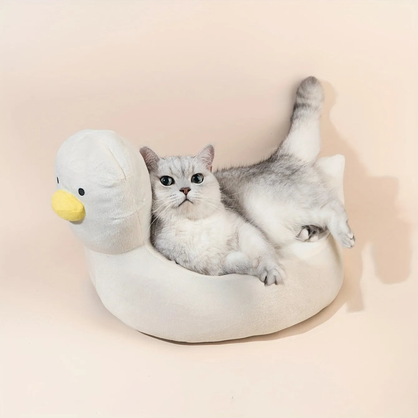 Blue duck-shaped fluffy pet sofa bed for small dogs and cats on a white background.