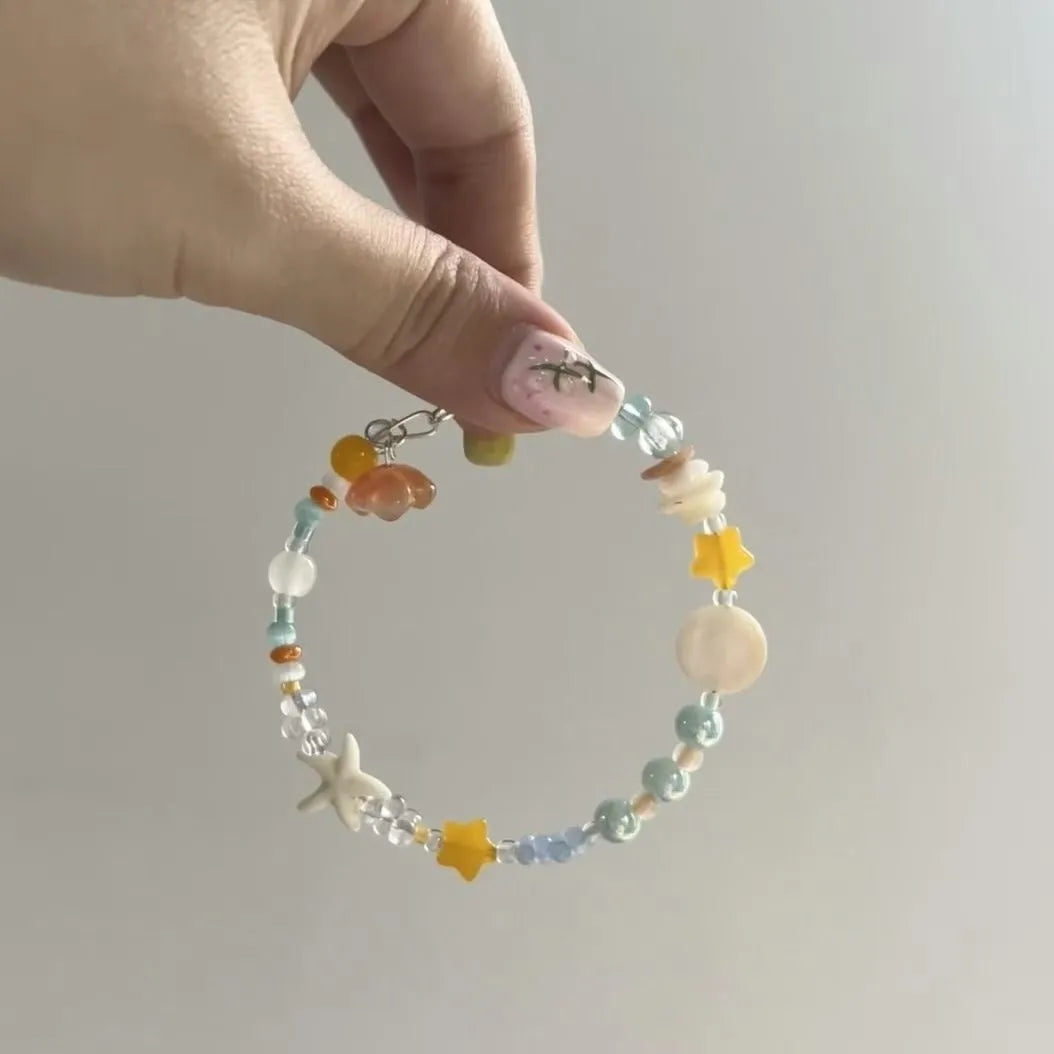 Orange sea colour alloy bracelet with diamond-shaped charms and round decorative elements for women