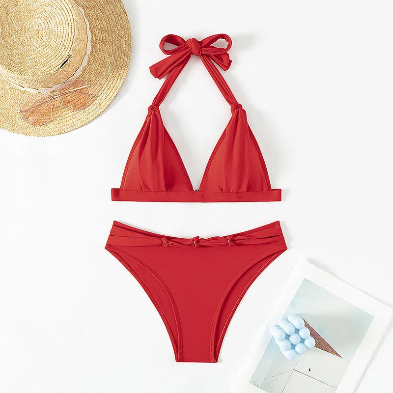 Red women's lace-up halterneck bikini set with split shorts for swimming