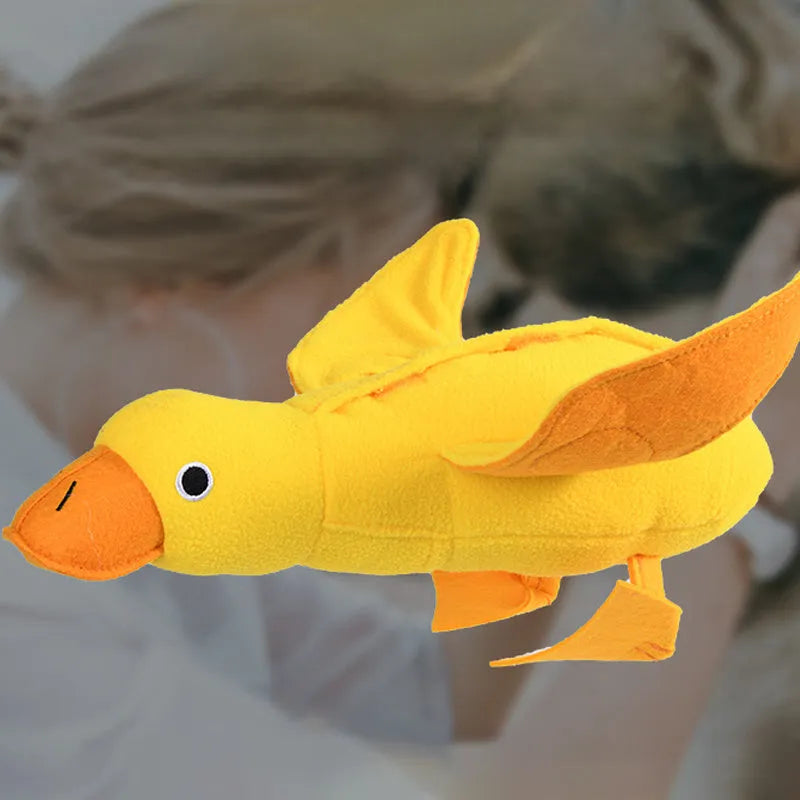 Yellow teddy dog toy with integrated duck doll, a pet training aid with sound and treat dispenser.
