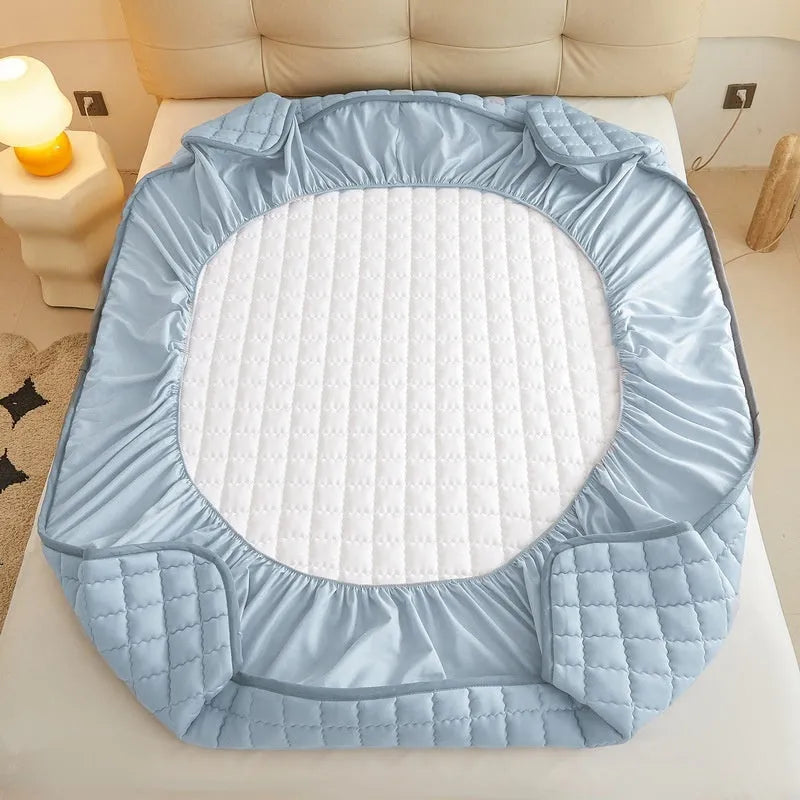 Washed cotton waterproof fitted sheet in light grey colour with elasticated corners on a mattress