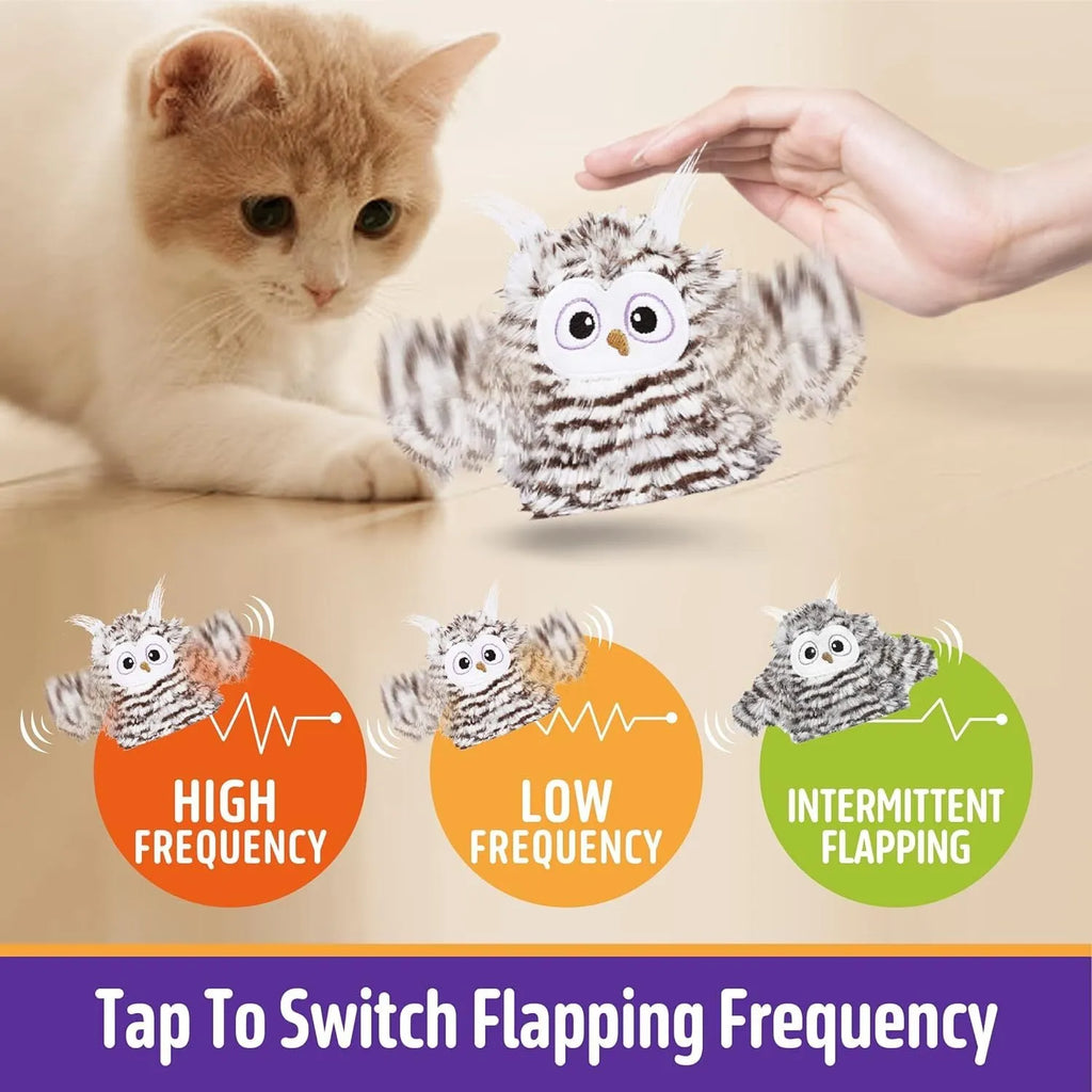 Grey plush owl automatic cat toy with beating wings on flat surface with USB charging cable