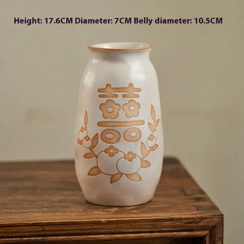 Chinese hand-painted ceramic vase with persimmon fruit designs on wooden desktop