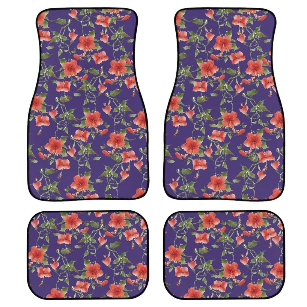 Four-piece set of thick black rubber car floor mats with printed patterns laid out for a vehicle.
