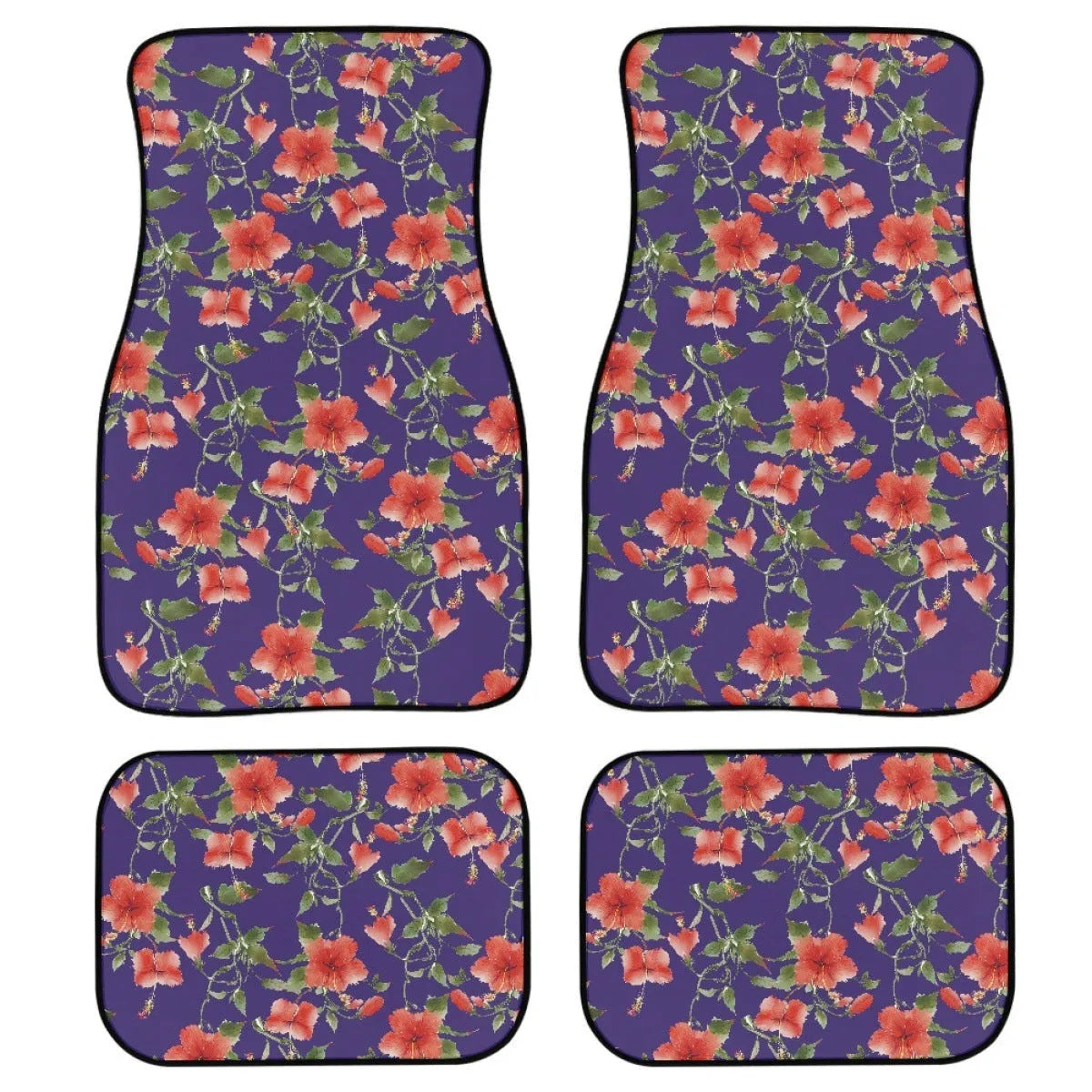 Four-piece set of thick black rubber car floor mats with printed patterns laid out for a vehicle.