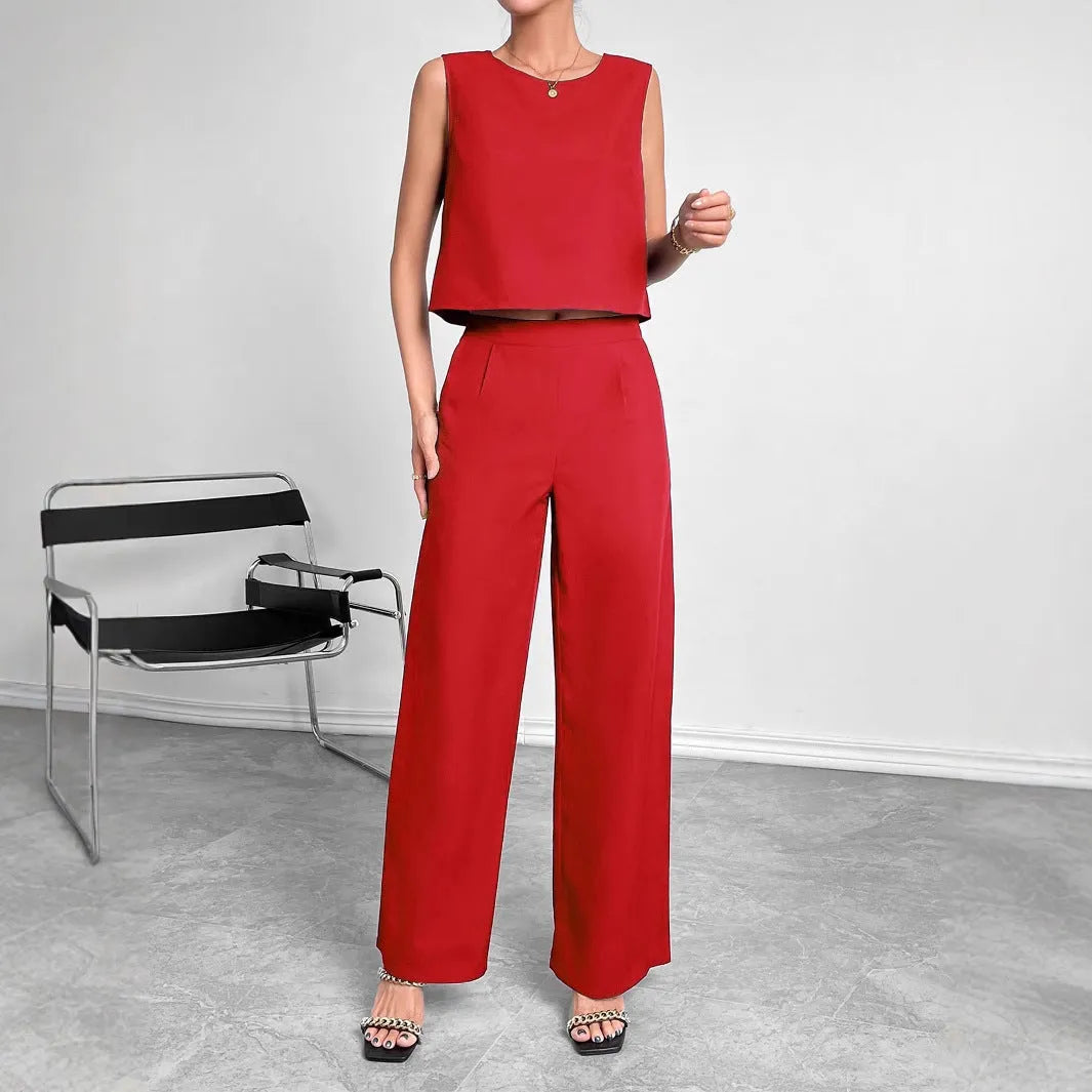 Women's red polyester two-piece set with sleeveless top and wide leg trousers displayed flat