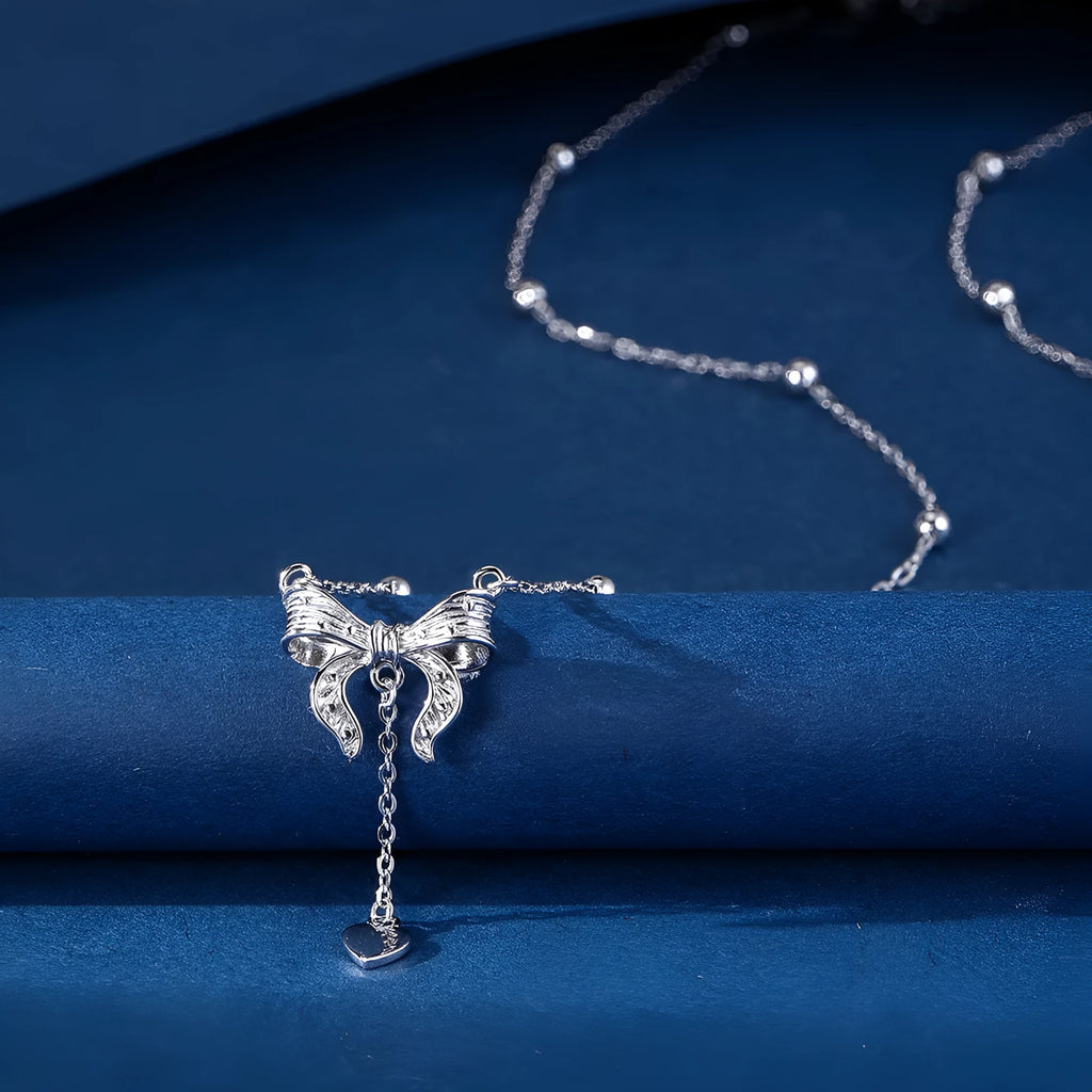 Women's 925 silver butterfly heart and bow pendant necklace on an adjustable O-ring chain.