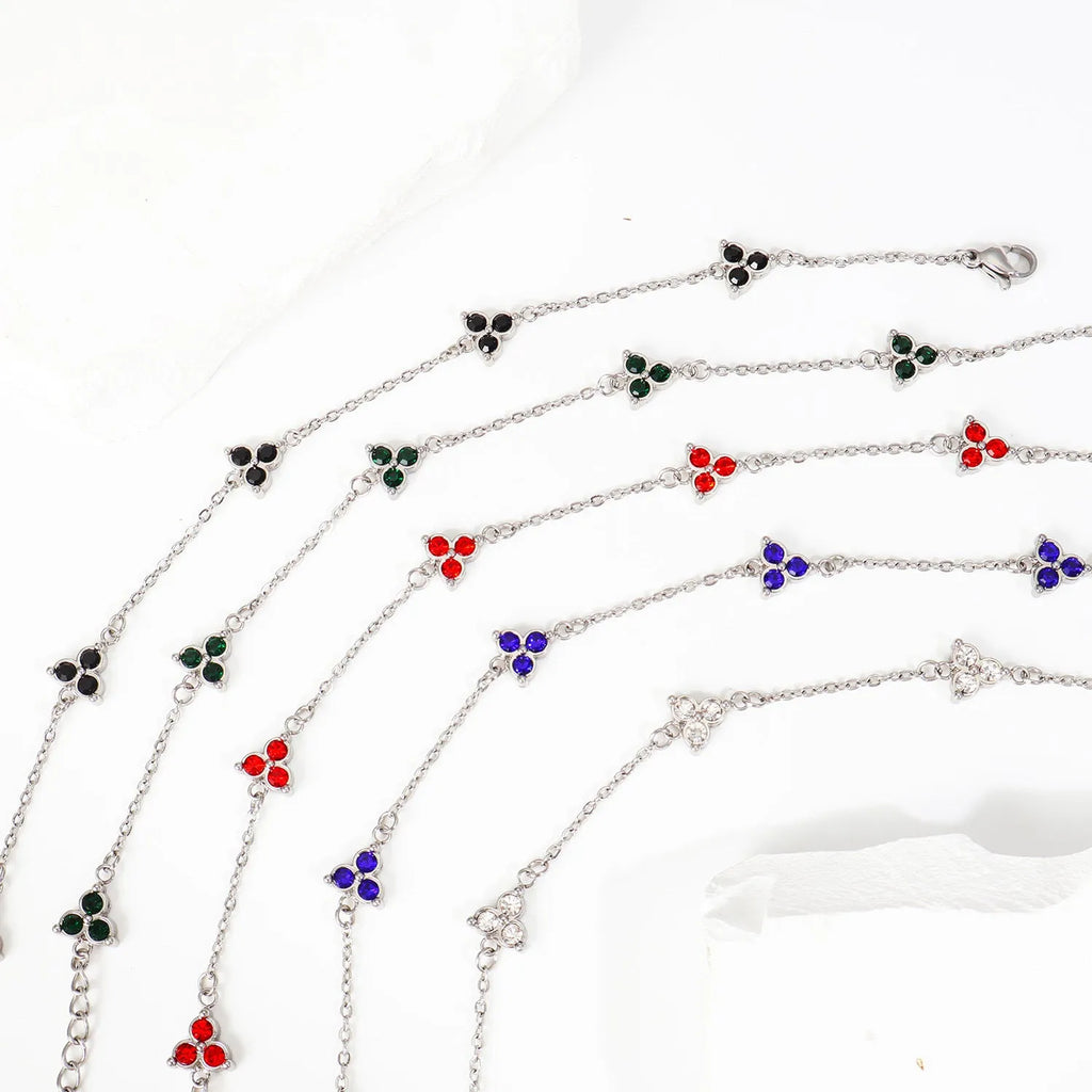 Women's stainless steel bracelet with a geometric triangle pendant, shown in gold and steel tone options with coloured stones.