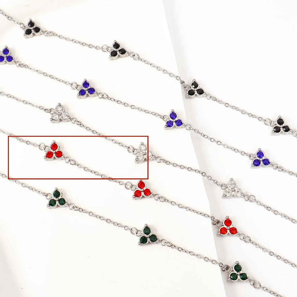Women's stainless steel bracelet with a geometric triangle pendant, shown in gold and steel tone options with coloured stones.