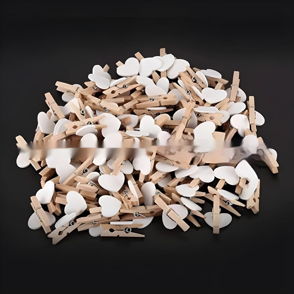 Five solid wood heart-shaped clips in different colours showing handmade construction details