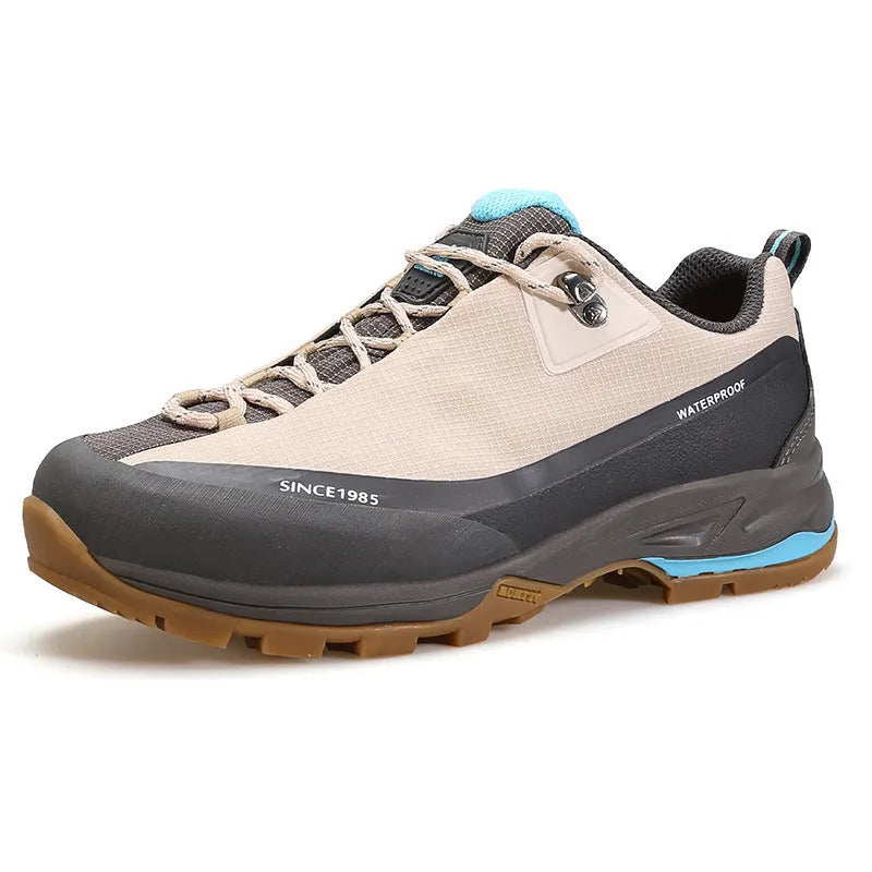 Men's low-top hiking boot in black with front lace-up, rubber outsole, and leather mesh upper.