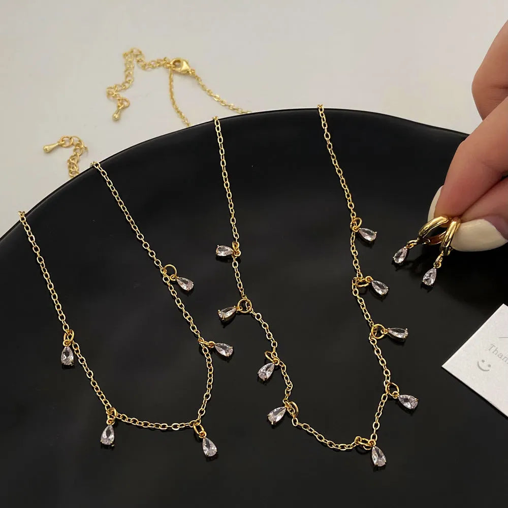 Zircon geometric necklace, earrings, and anklet set with meteor shower detail on a white background.
