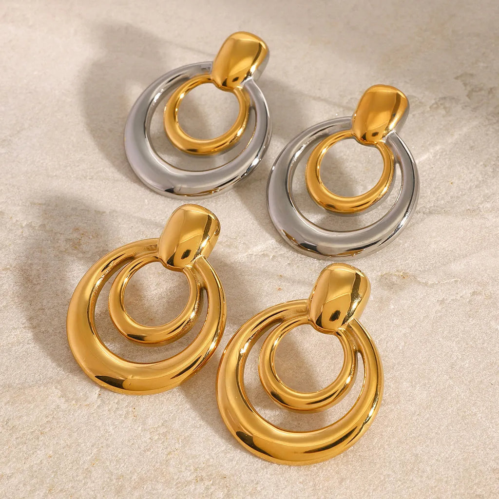 Golden round titanium steel hollow stud earrings with double layer construction and hypoallergenic properties