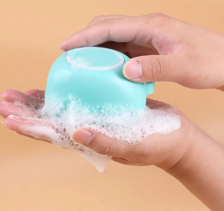 Blue silicone dog bath brush with rubber fingertips for pet grooming during bath time